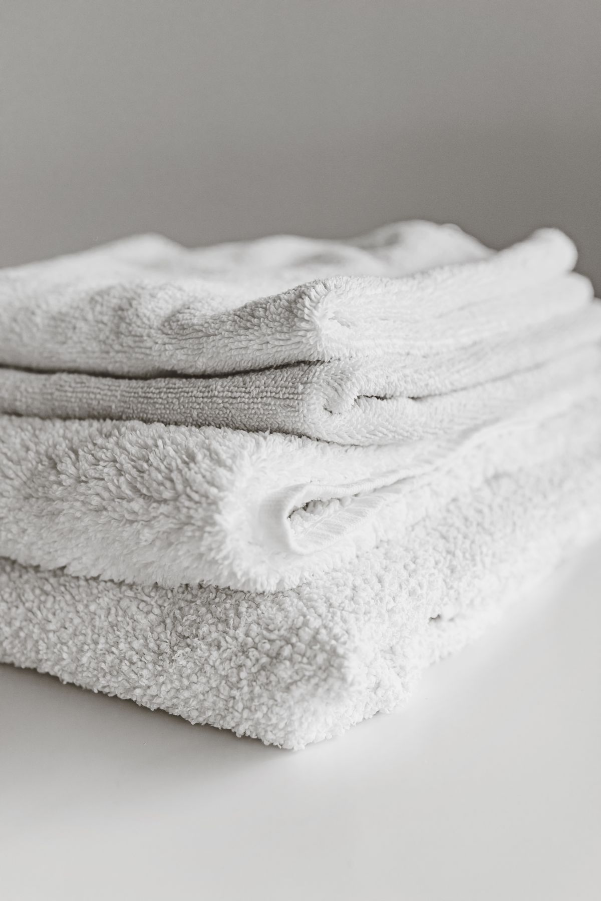 Fresh white towels folded in a neat stack
