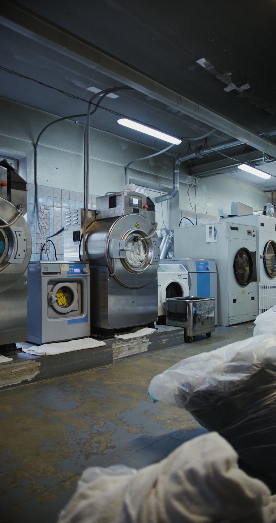 Laundry workers handling garments together